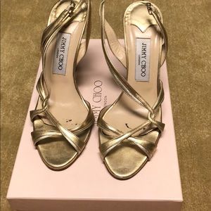 Jimmy Choo gold strapped heels.